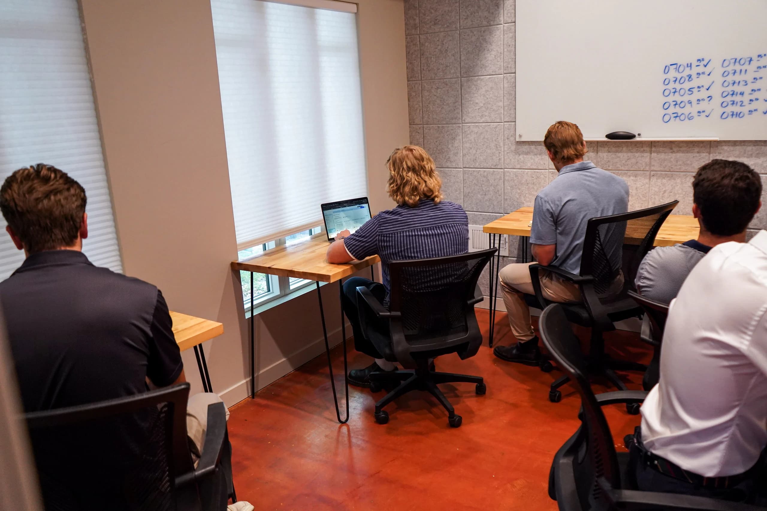 A team working together in the large private office at Merritt Workspace, Denver
