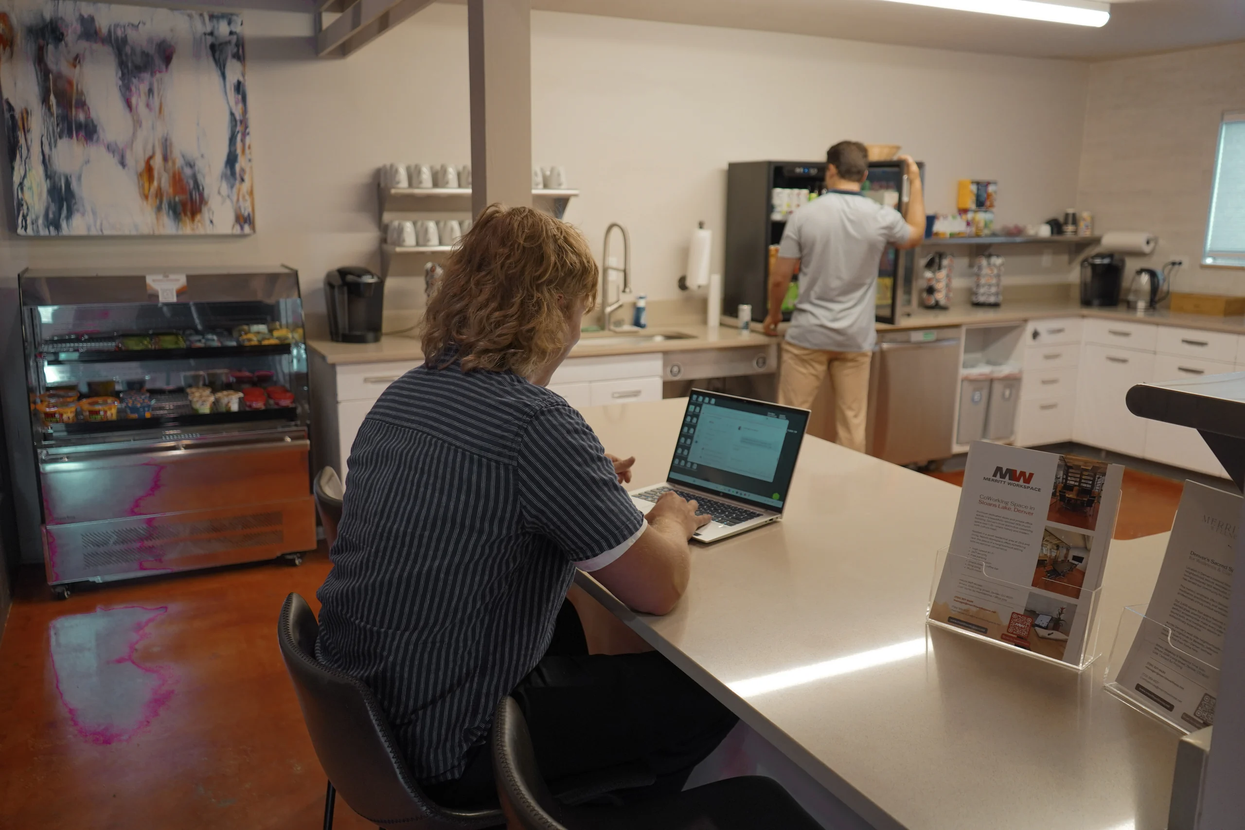 A member working at the kitchen counter at Merritt Workspace in Sloan's Lake, Denver